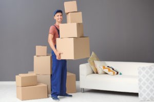 delivery man holding boxes indoors