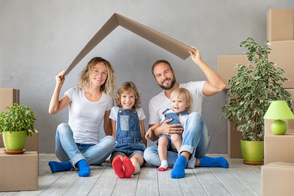 happy family with two kids playing into new home