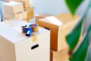 house moving concept with stacked cardboard boxes room