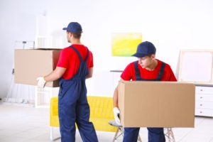 male workers with boxes furniture new house