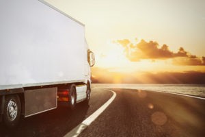 white truck moving road natural landscape sunset
