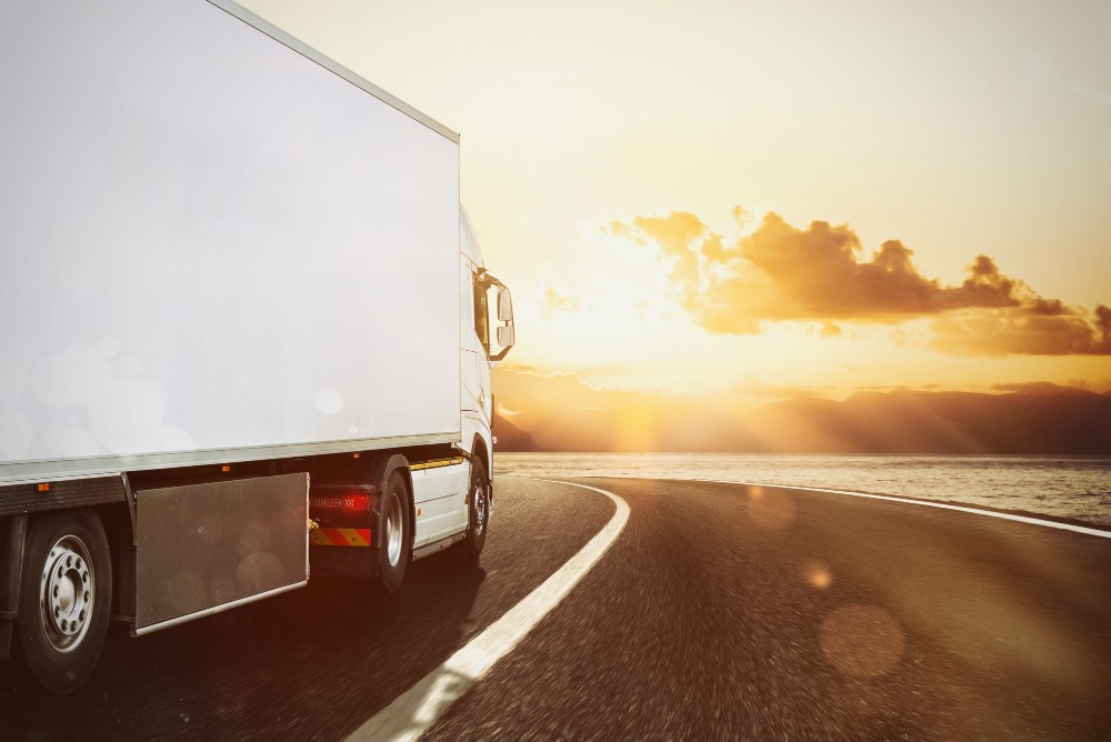 white truck moving road natural landscape sunset