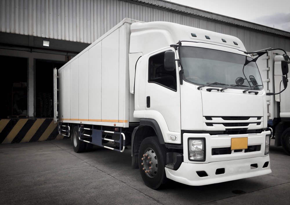 white trucks docking load cargo distribution warehouse